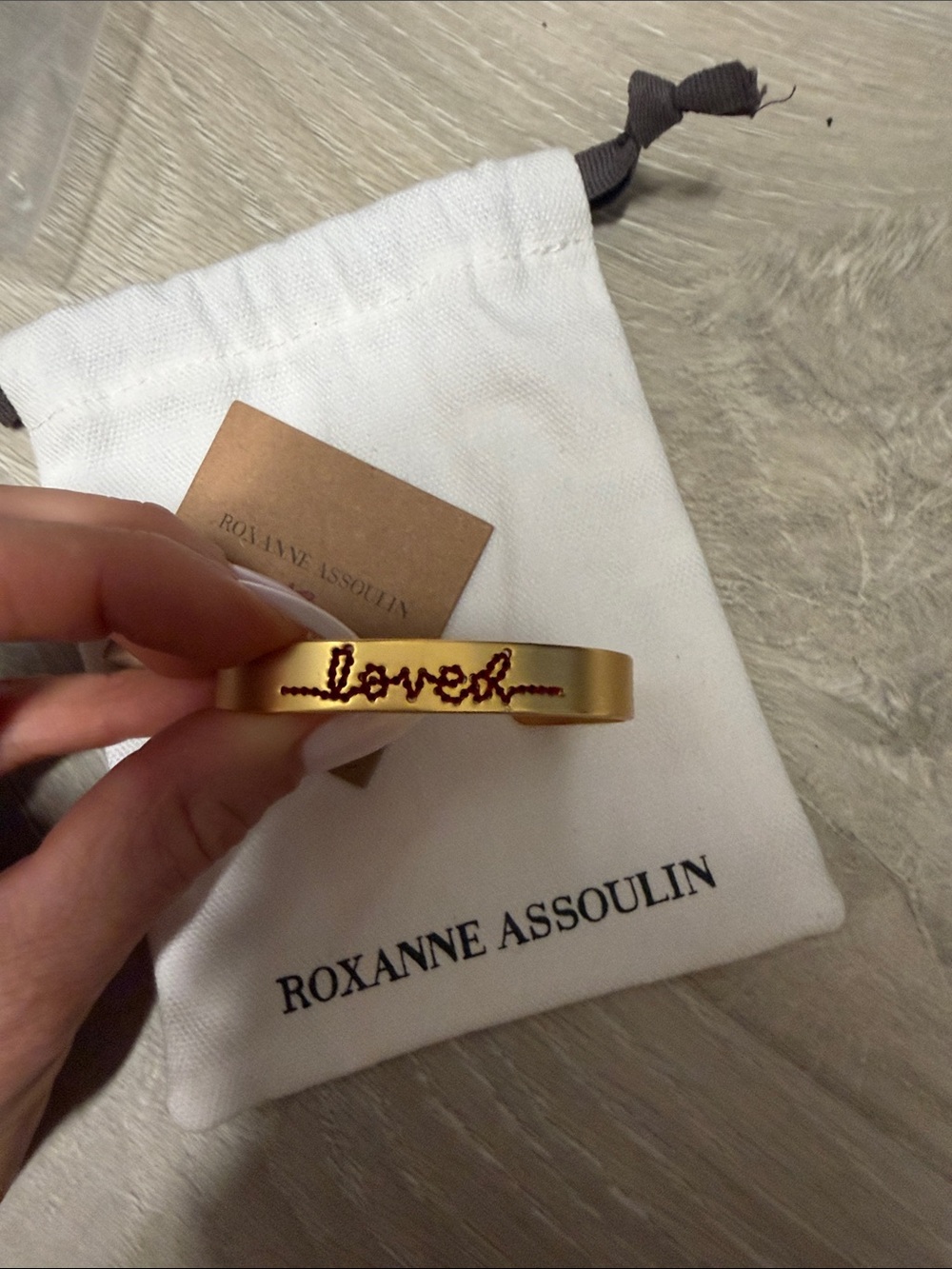 Roxanne Assoulin Gold Bracelet with Red "loved" Script brand new
